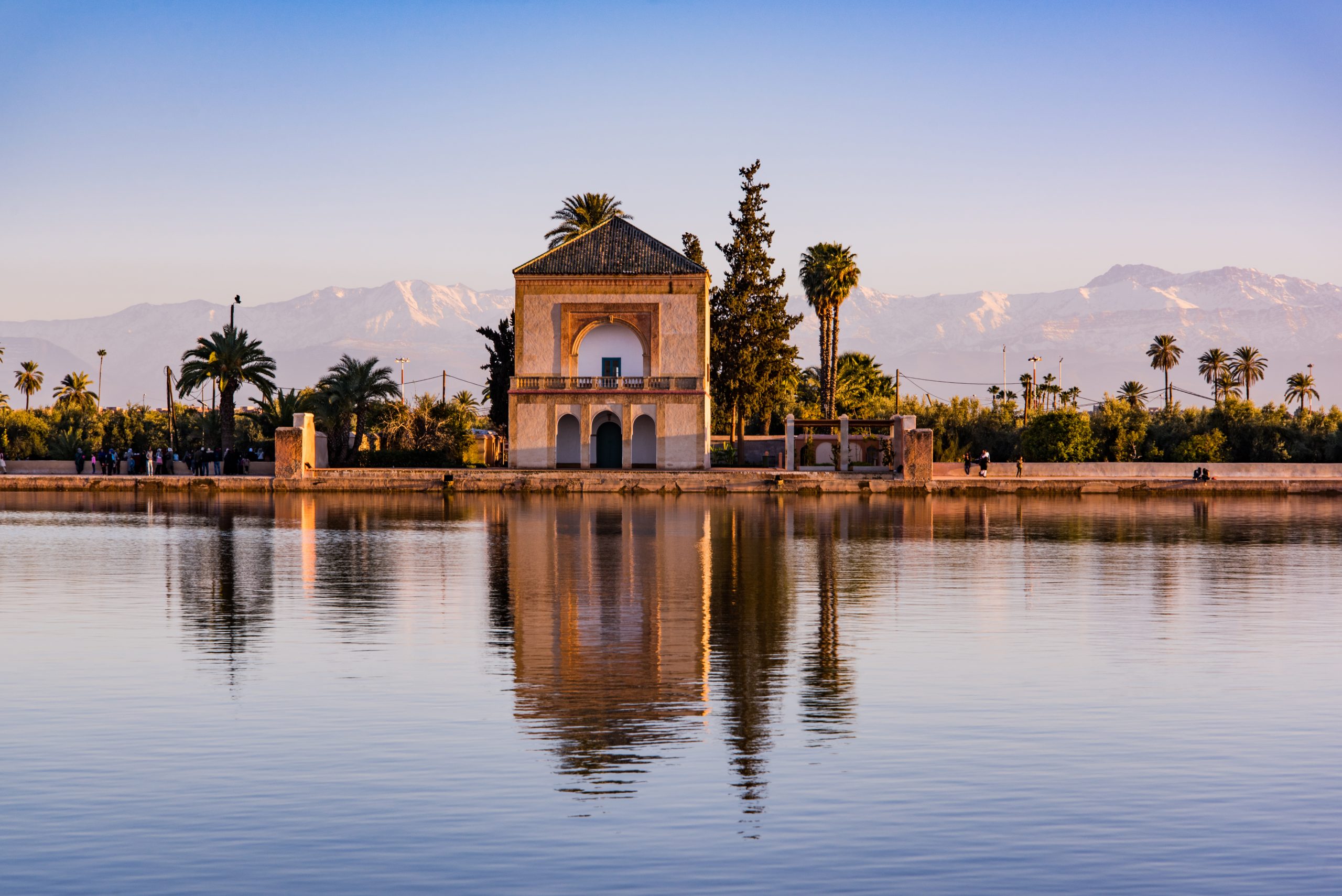 Saadian pavilion,Menara gardens and Atlas in Marrakech, Morocco, Africa at sunset. Water reflection.